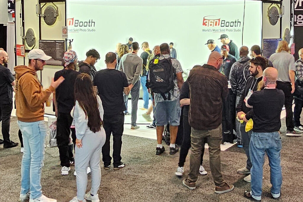 Crowd of dealers gathered at the 360Booth vehicle photo studio at the NADA Show