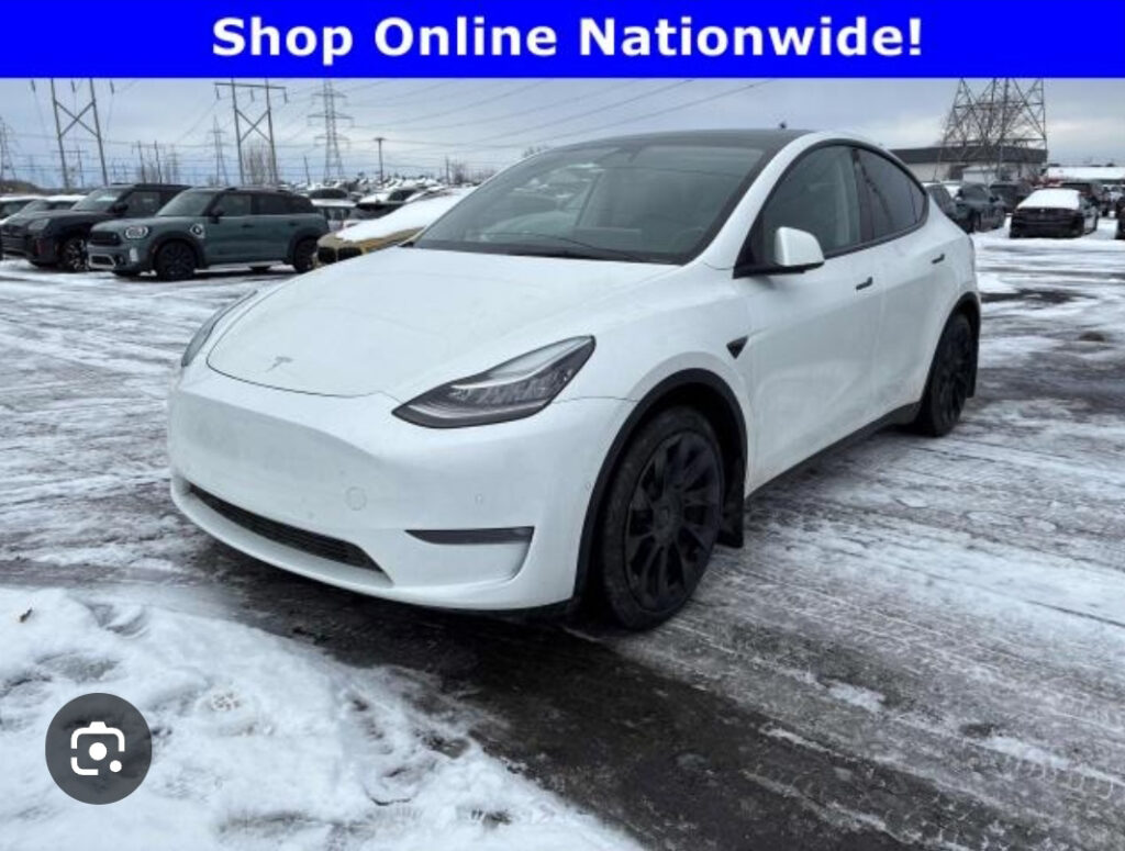 A car on a used car lot in the snow