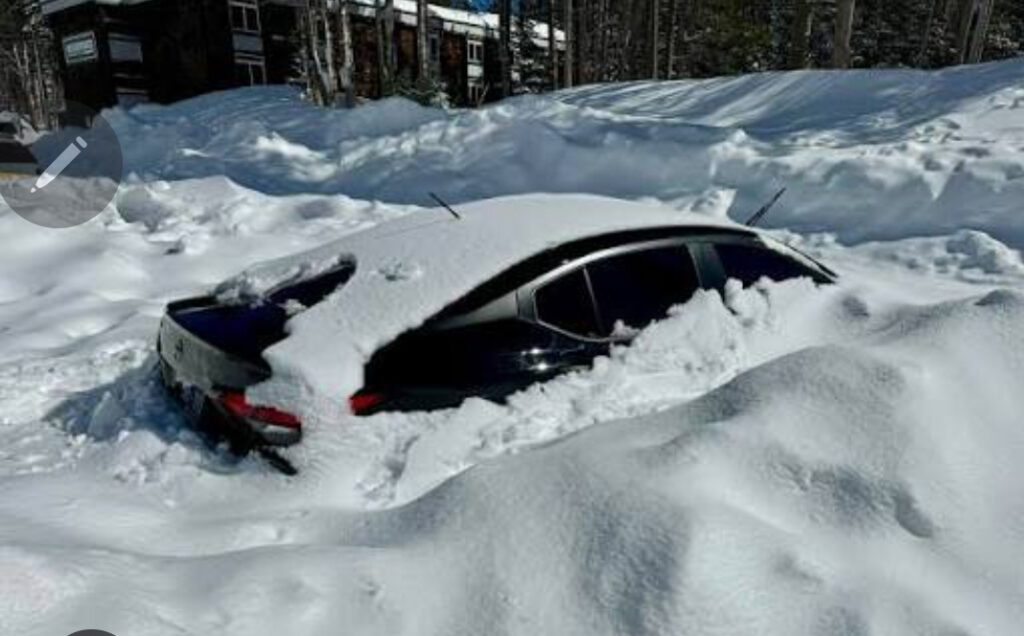 a car buried in snow