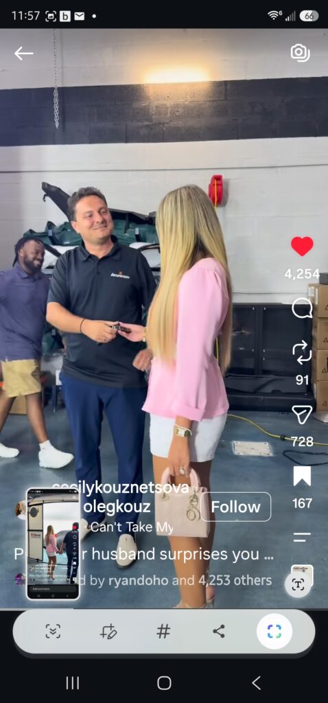 A man and a woman exchange the key of her new car