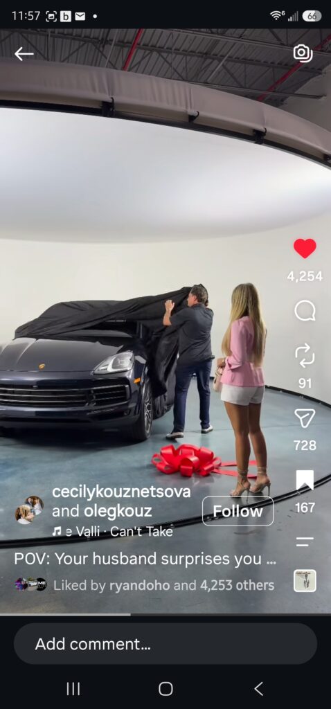 A woman watches her husband unveil her new car