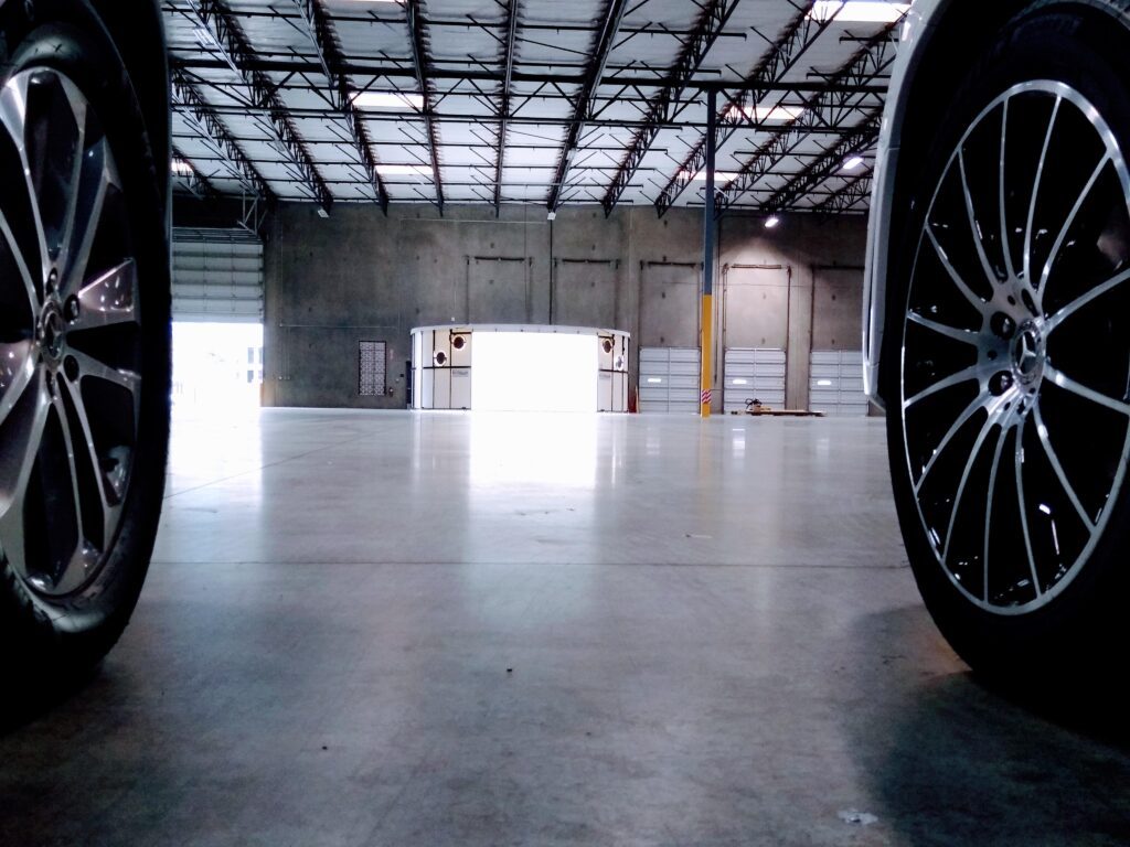 360Booth Vehicle Photo Studio in a dealership warehouse with two cars ready to enter