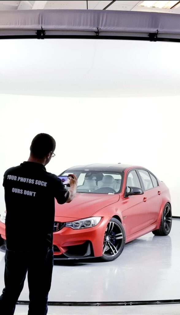 Staff photograph a car in a 360Booth car photo booth