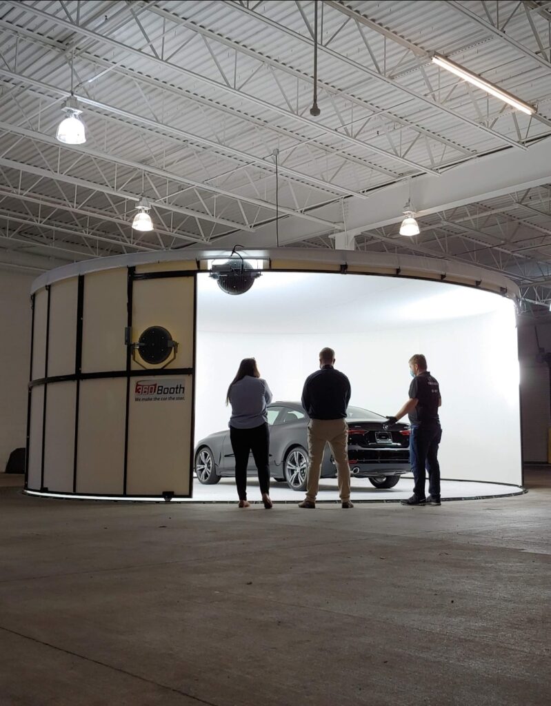 Staff learning how to photograph a car in a 360Booth car photo booth