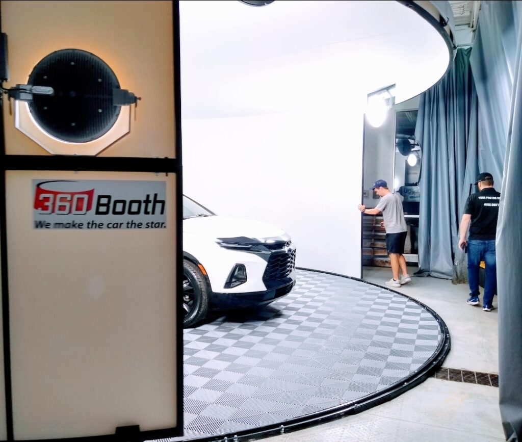 Staff photograph an SUV in a 360Booth SUV photo booth