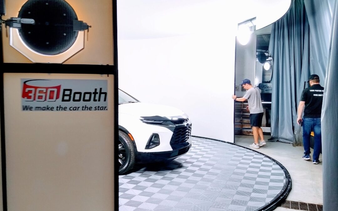 Dealership staff photograph a real SUV inside a 360Booth vehicle photo studio